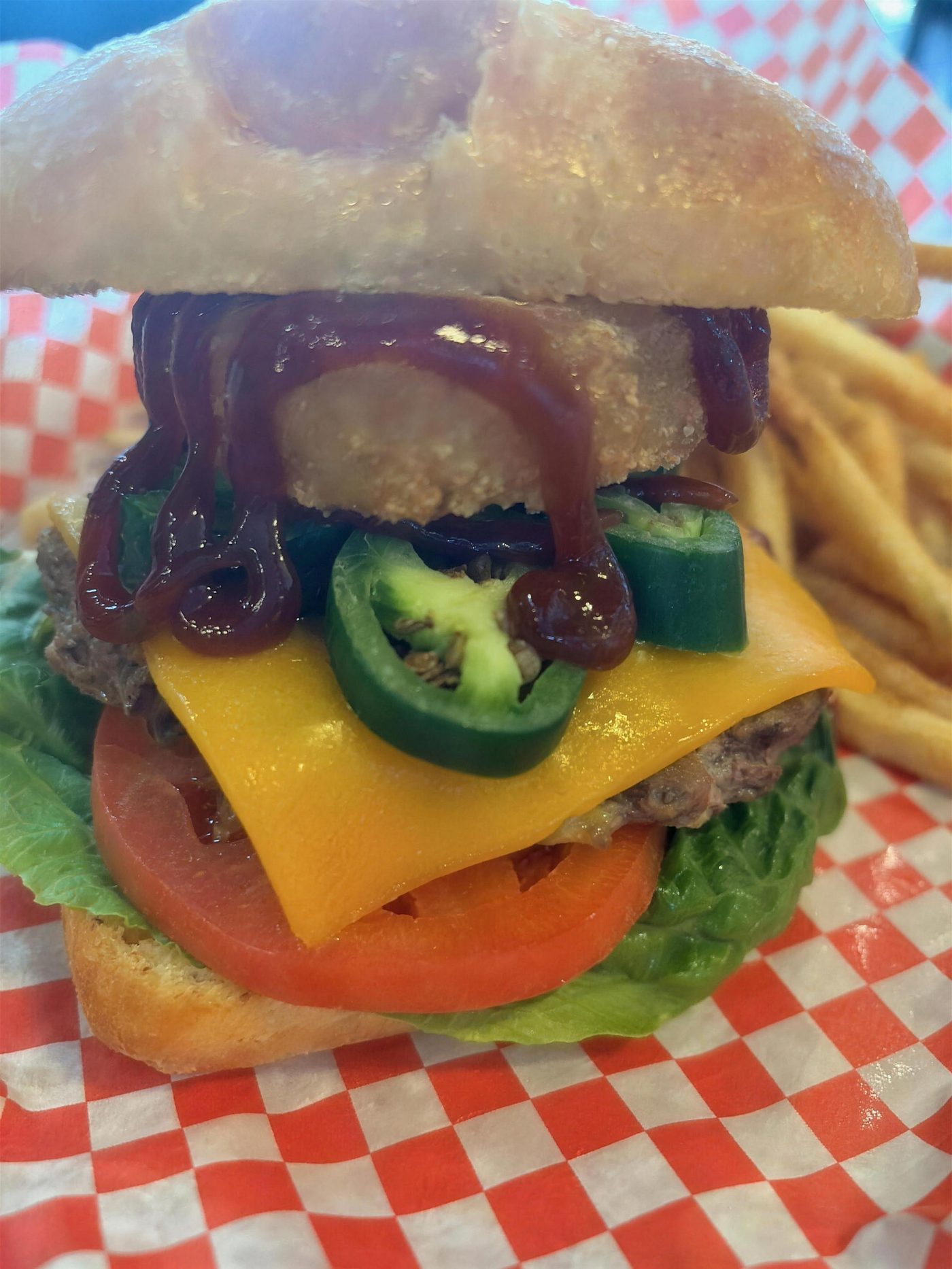 The Spicy Cowboy burger on a ciabatta roll with cheddar, jalapenos and an onion ring